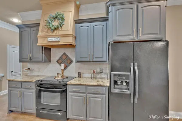 a kitchen with sink refrigerator and cabinets