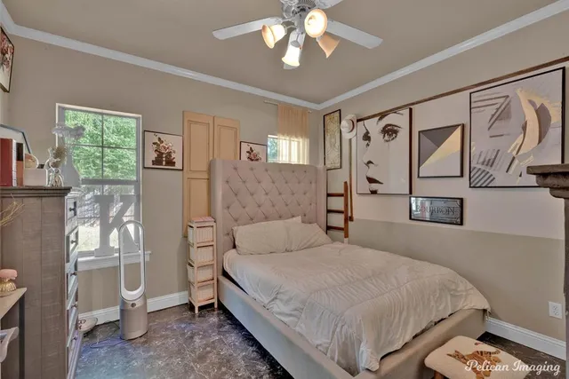 a bedroom with a large bed and a chandelier