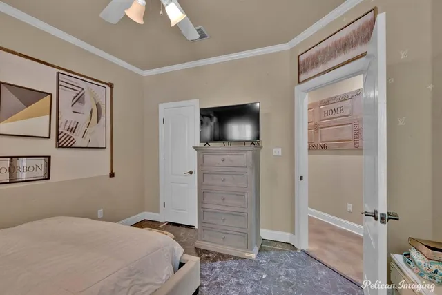a bedroom with a bed and a flat tv screen on dresser