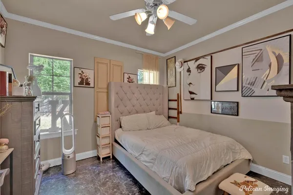 a bedroom with a large bed and a chandelier