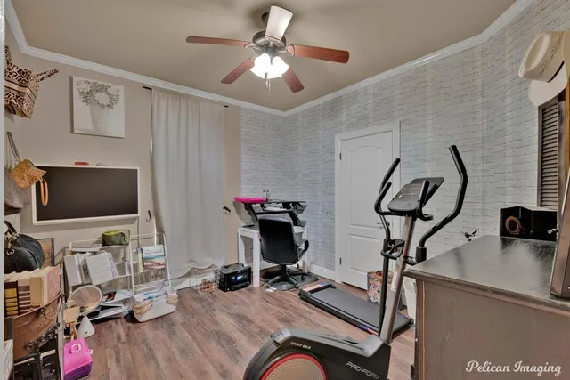 a view of a workspace with furniture and a flat screen tv