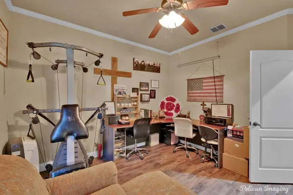 a view of a workspace with furniture and a window