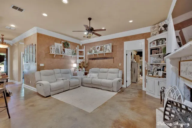 a living room with furniture and kitchen view