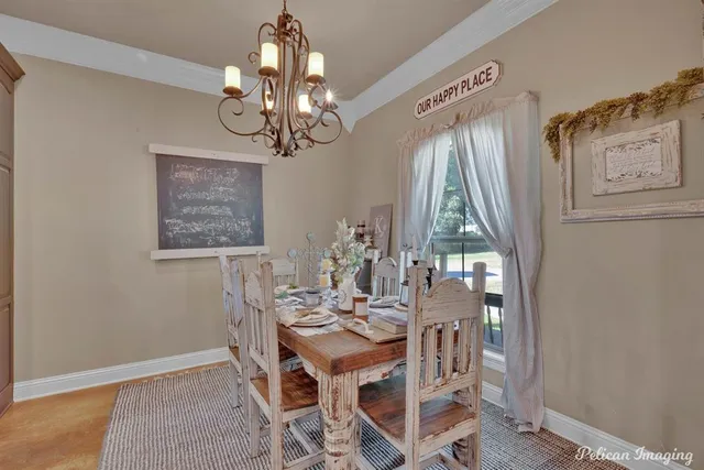 a view of a dining room with furniture and chandelier