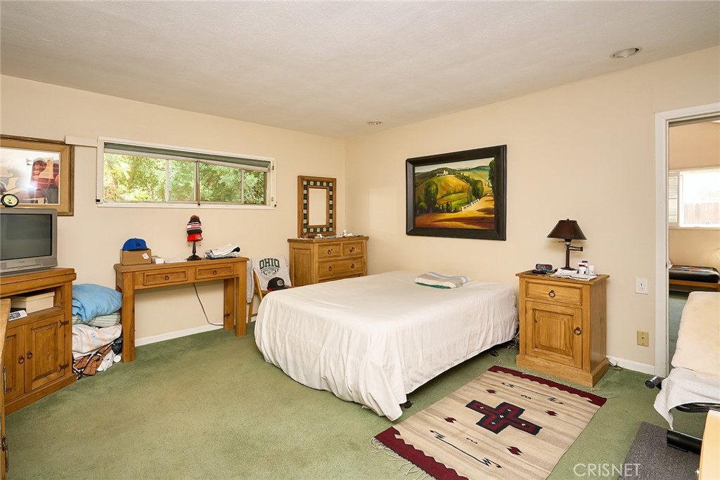 10370 Topeka Drive Porter Ranch, CA 91326 - Photo 11 of 33 a bed room with a bed and a chair
