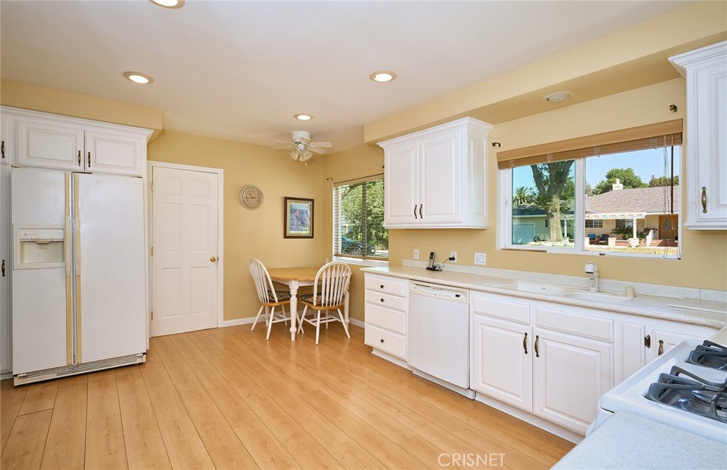 10370 Topeka Drive Porter Ranch, CA 91326 - Photo 14 of 33 a large kitchen with a table and chairs in it