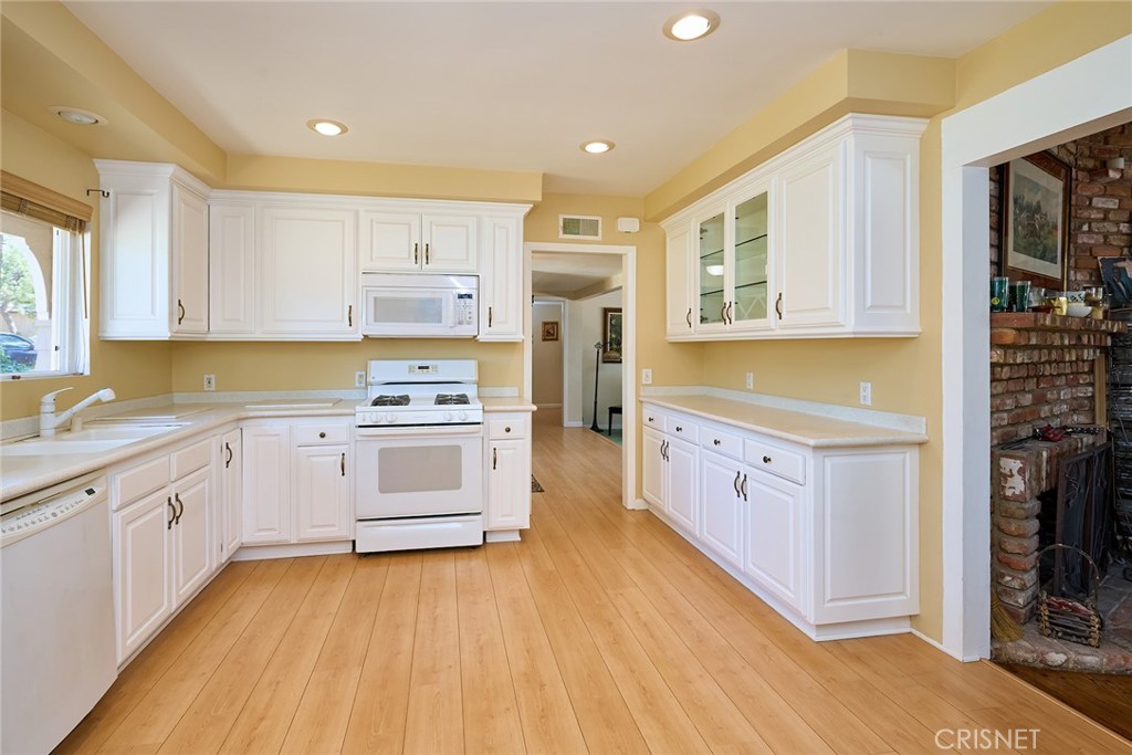 10370 Topeka Drive Porter Ranch, CA 91326 - Photo 16 of 33 a kitchen with stainless steel appliances granite countertop a stove and a sink