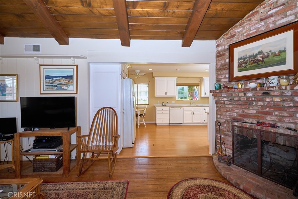 10370 Topeka Drive Porter Ranch, CA 91326 - Photo 18 of 33 a living room with furniture a flat screen tv and a fireplace