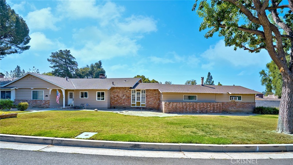 10370 Topeka Drive Porter Ranch, CA 91326 - Photo 2 of 33 a front view of a house with a garden and trees
