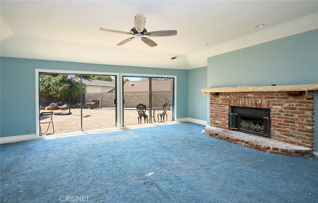 10370 Topeka Drive Porter Ranch, CA 91326 - Photo 21 of 33 a view of an empty room with a fireplace and a window