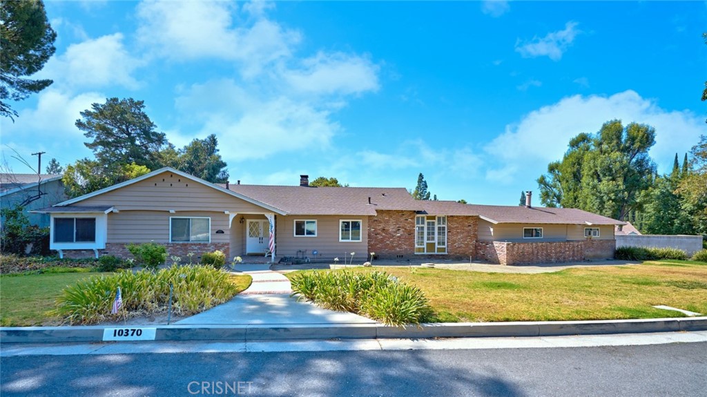 10370 Topeka Drive Porter Ranch, CA 91326 - Photo 3 of 33 a front view of a house with a yard