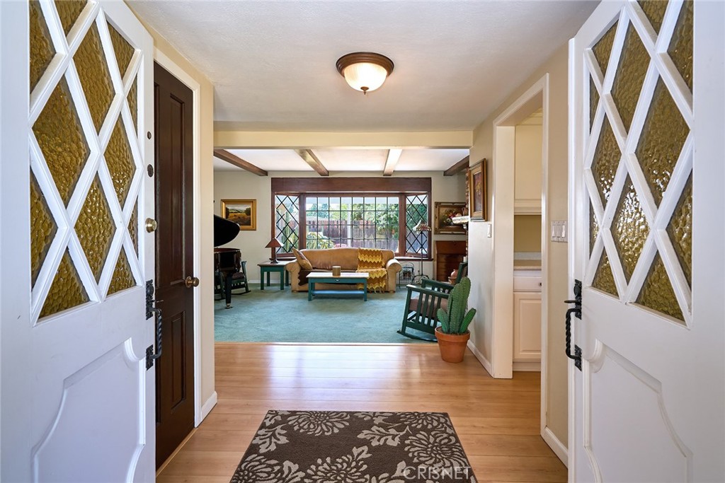 10370 Topeka Drive Porter Ranch, CA 91326 - Photo 5 of 33 a hallway with a couch and a window