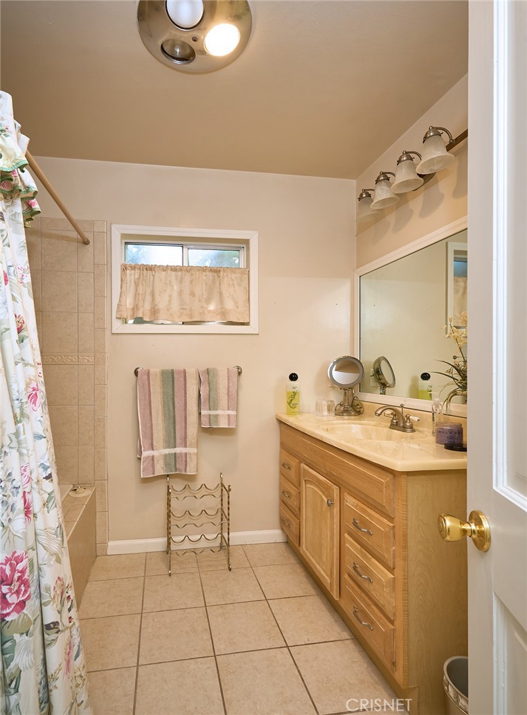 10370 Topeka Drive Porter Ranch, CA 91326 - Photo 9 of 33 a bathroom with a sink a toilet and mirror