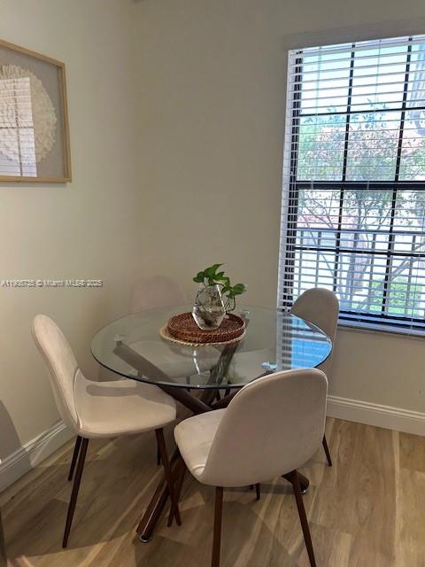 15865 Southwest 6th Place, Unit 201 Pembroke Pines, FL 33027 - Photo 14 of 80 a view of a dining room with furniture and a window