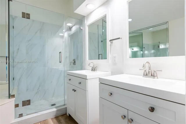 an aerial view of residential houses with outdoor space and trees