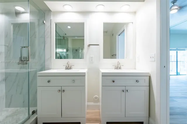 an aerial view of residential houses with outdoor space and trees