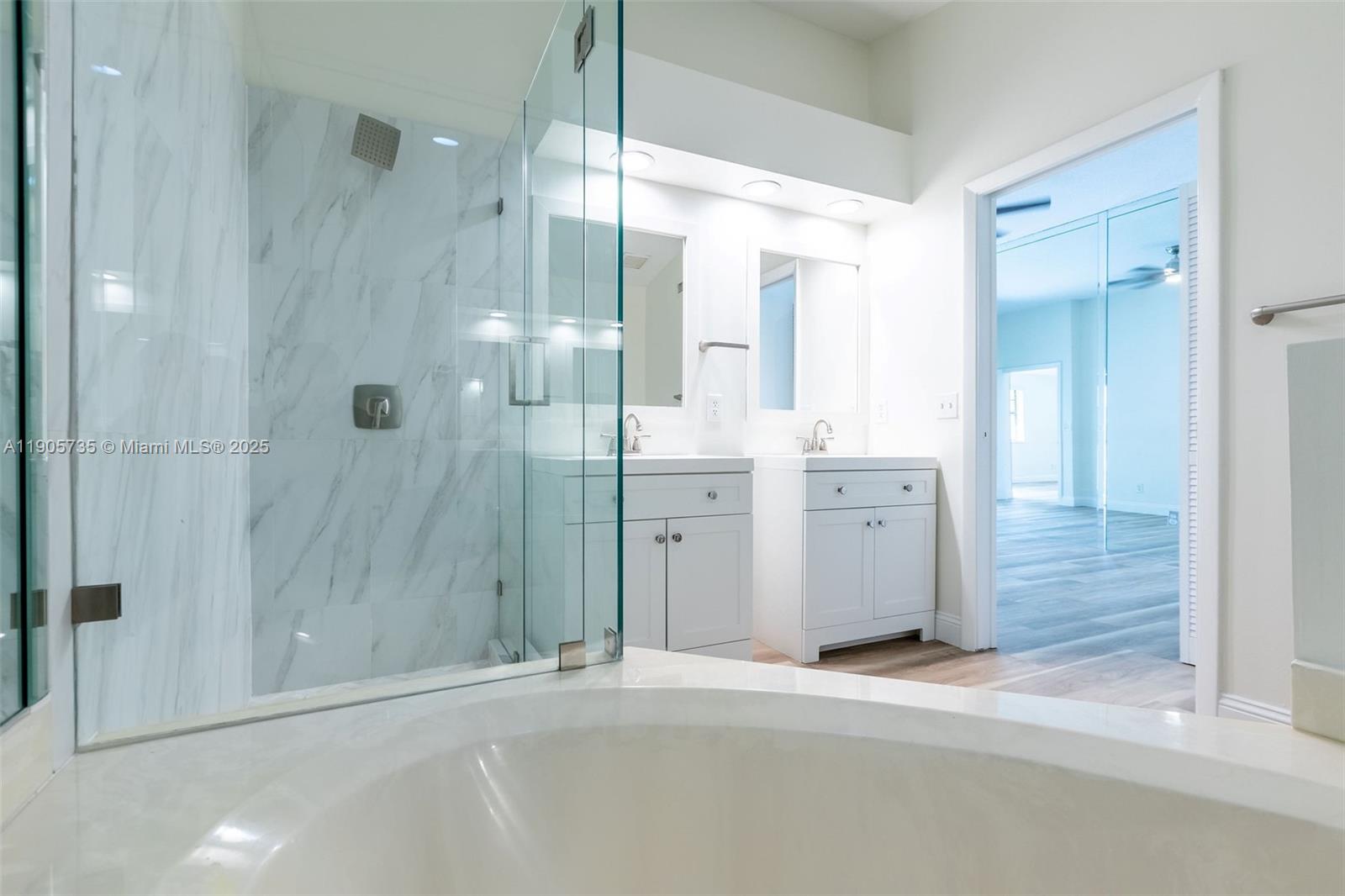 15865 Southwest 6th Place, Unit 201 Pembroke Pines, FL 33027 - Photo 28 of 80 a bathroom with a double vanity sink a shower and a mirror