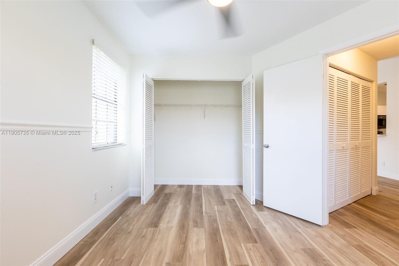 15865 Southwest 6th Place, Unit 201 Pembroke Pines, FL 33027 - Photo 43 of 80 a view of a room with wooden floor and a window
