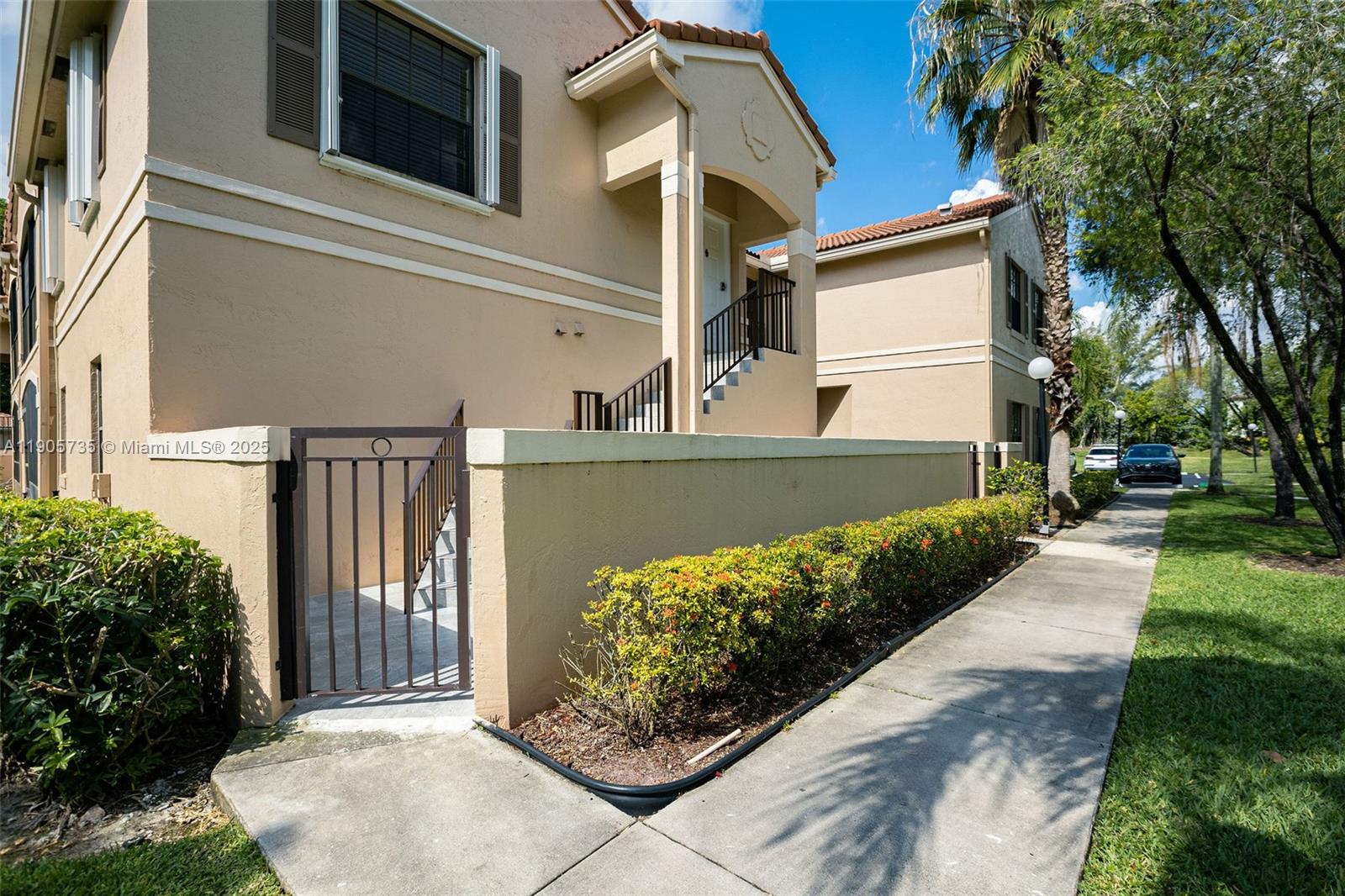15865 Southwest 6th Place, Unit 201 Pembroke Pines, FL 33027 - Photo 51 of 80 a view of a house with a yard and potted plants
