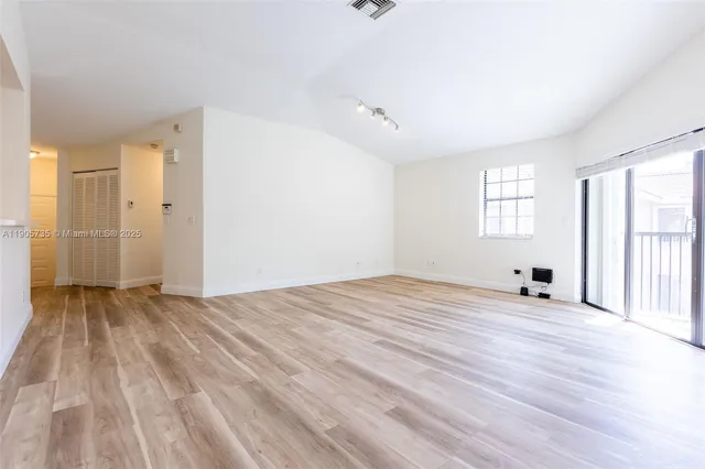 a view of a livingroom with a ceiling fan and wooden floor