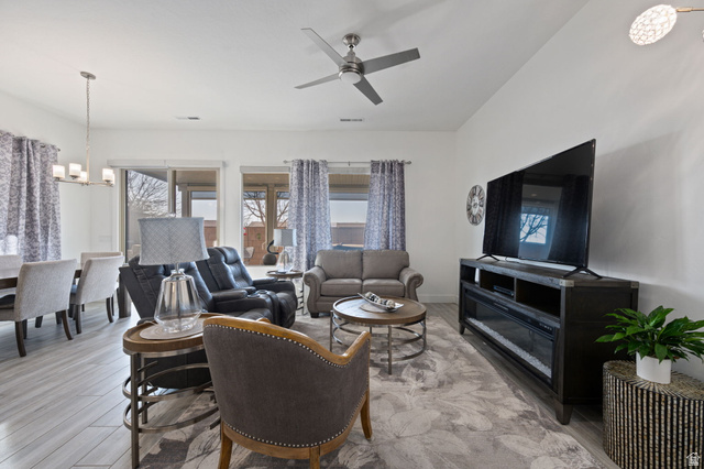 4708 Martin Drive St. George, UT 84790 - Photo 9 of 28 Living room featuring a chandelier, light wood-type flooring, and a ceiling fan