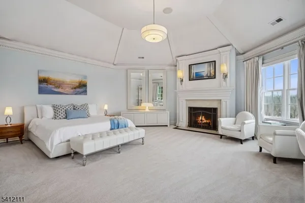 a spacious bedroom with a bed and a fireplace