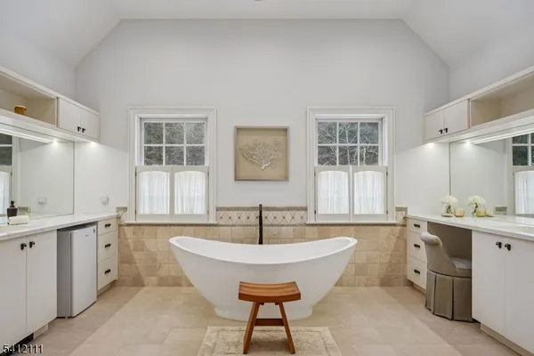 a spacious bathroom with a sink double vanity and a tub