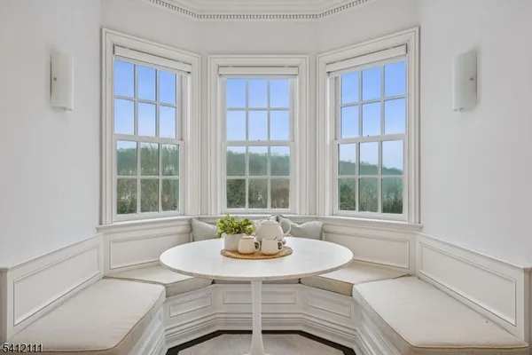 a dining room with furniture and window