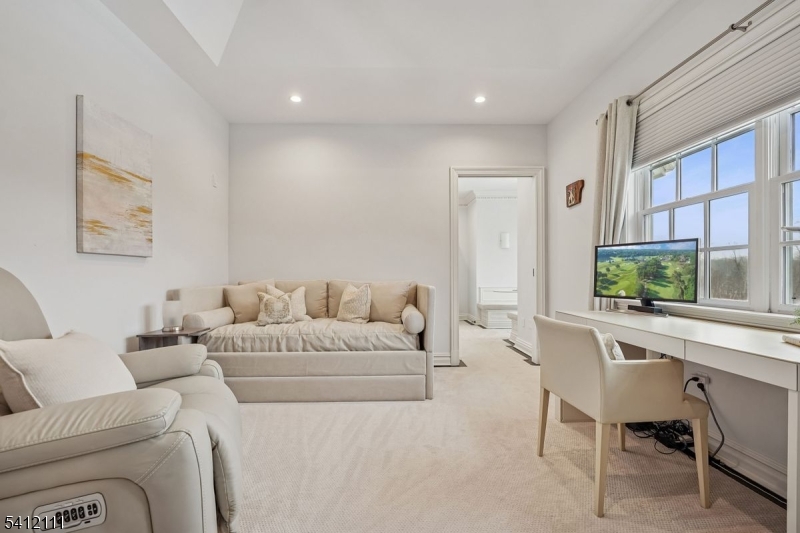 89 Mosle Road Peapack-Gladstone, NJ 07931 - Photo 21 of 45 a living room with furniture a flat screen tv and a large window