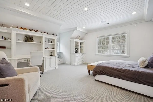 a spacious bedroom with a bed and a couch