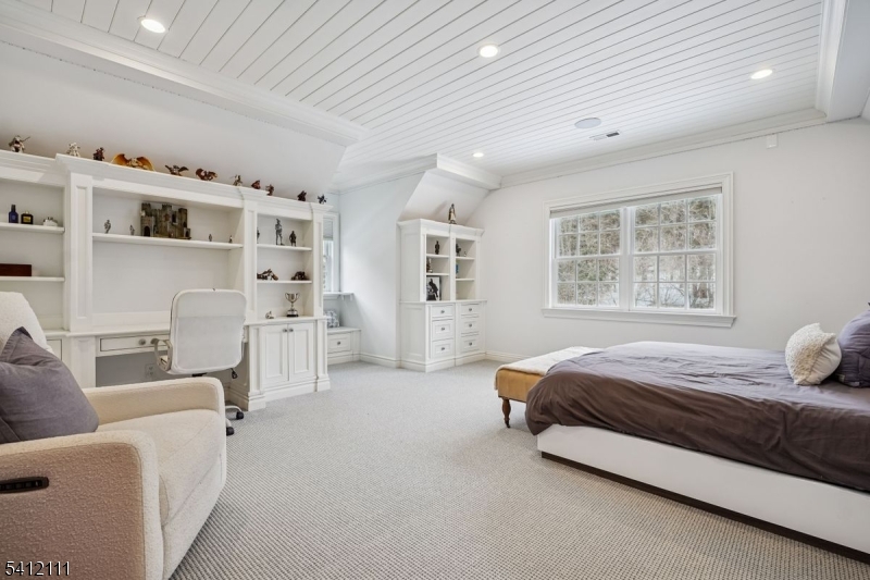 89 Mosle Road Peapack-Gladstone, NJ 07931 - Photo 26 of 45 a spacious bedroom with a bed and a couch