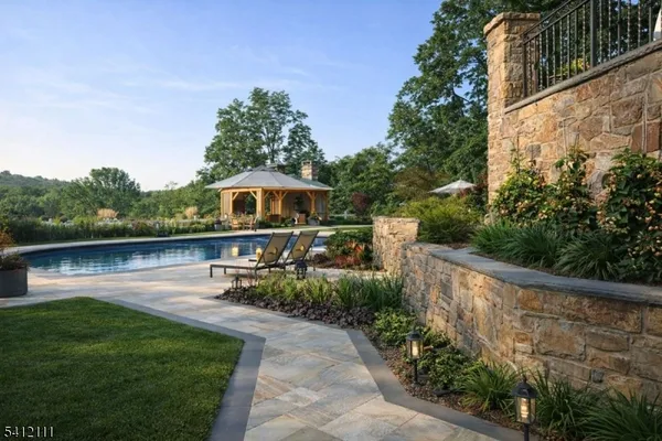 a view of a swimming pool and lounge chairs