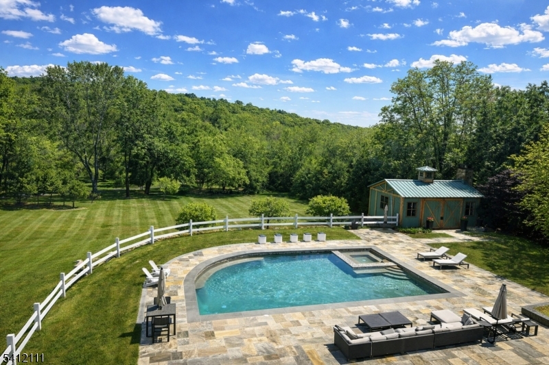 89 Mosle Road Peapack-Gladstone, NJ 07931 - Photo 31 of 45 a view of a swimming pool and lounge chairs