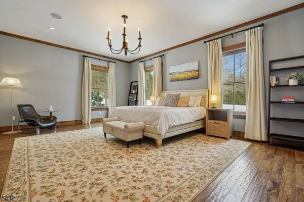 a bathroom with a granite countertop sink mirror and a large window