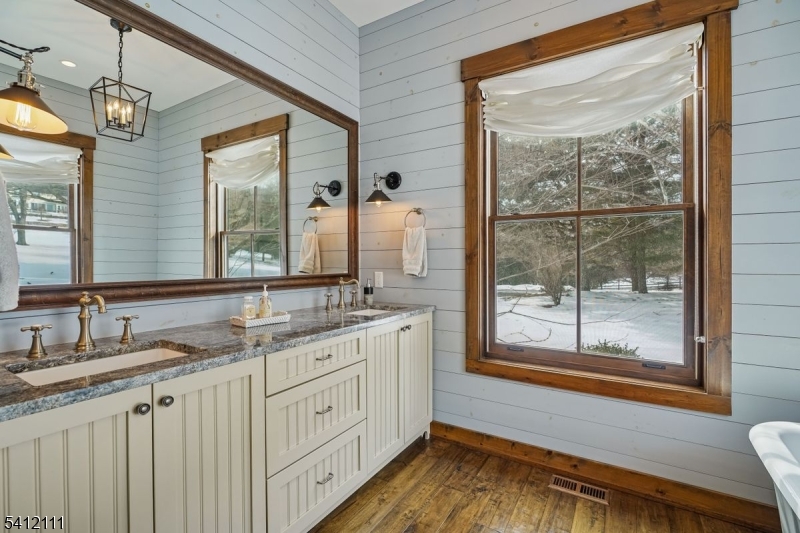 89 Mosle Road Peapack-Gladstone, NJ 07931 - Photo 40 of 45 a bathroom with a granite countertop sink mirror and a large window