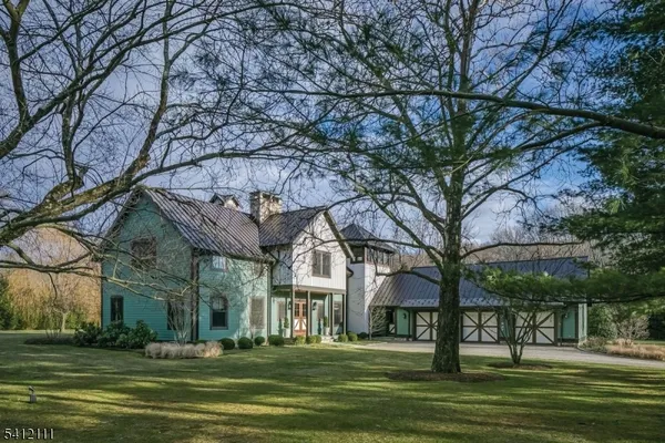 a front view of a building with trees