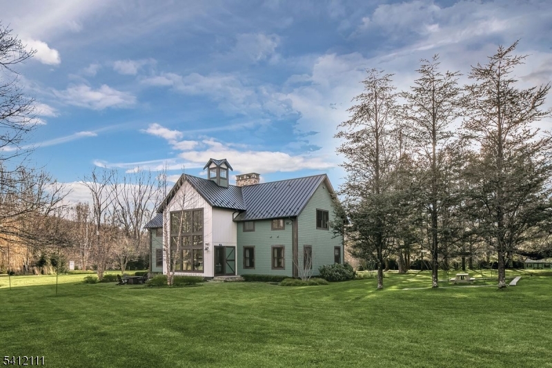 89 Mosle Road Peapack-Gladstone, NJ 07931 - Photo 44 of 45 a view of a white house with a big yard and large trees
