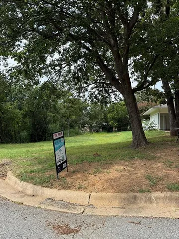 a view of a backyard with a tree