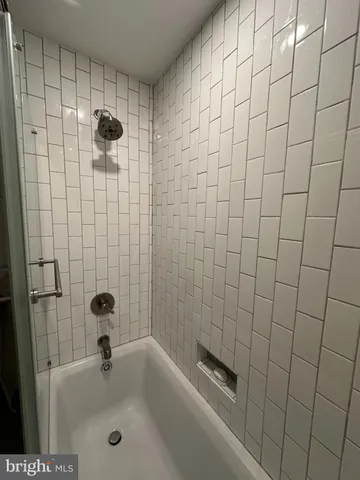 a bathroom with a shower and a bathtub