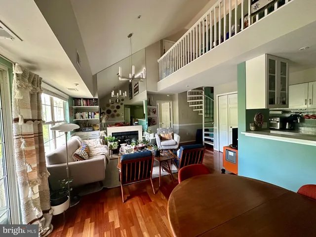 a living room with lots of furniture and kitchen view