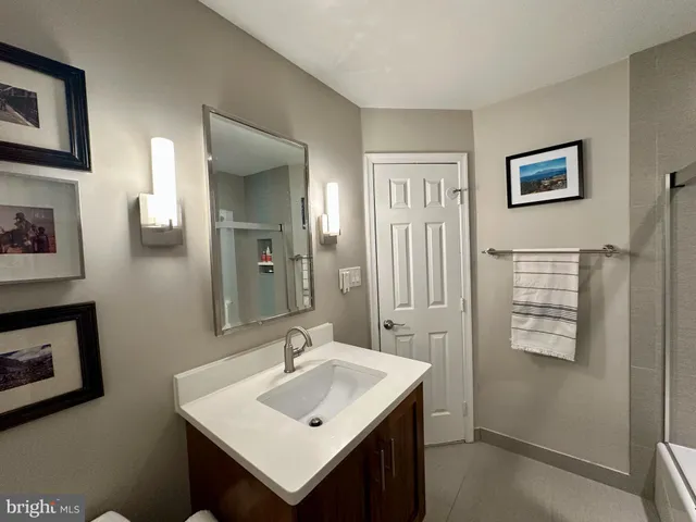 a bathroom with a sink mirror and vanity