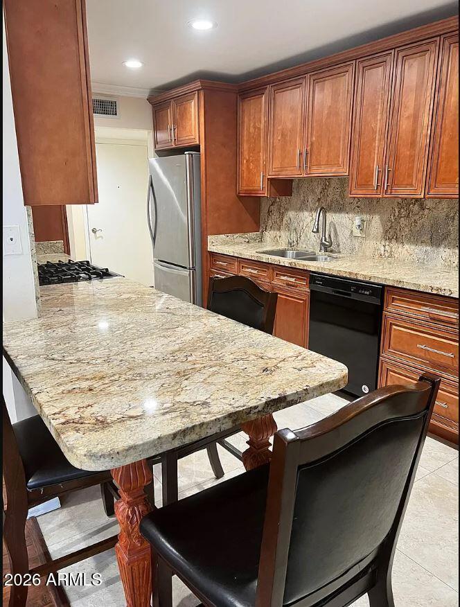 6767 North 7th Street, Unit 221 Phoenix, AZ 85014 - Photo 3 of 9 a kitchen with kitchen island granite countertop a stove a sink and a refrigerator