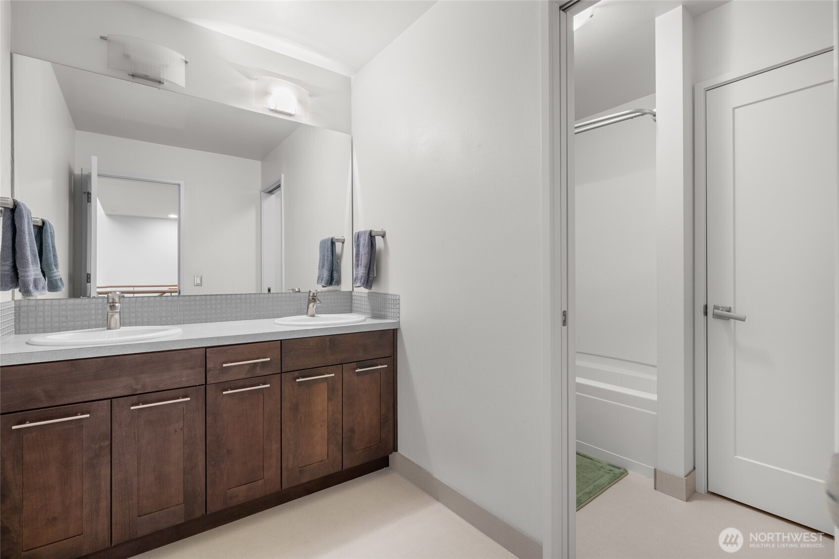 22326 2nd Place Southeast Bothell, WA 98021 - Photo 26 of 40 a bathroom with a double vanity sink and a mirror