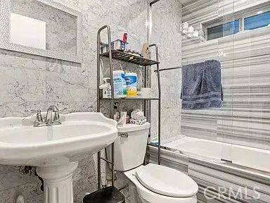 a bathroom with a sink toilet and mirror