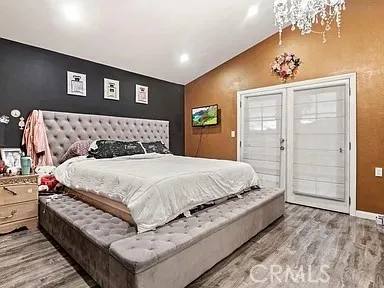 a bed sitting in a bedroom next to a bathroom