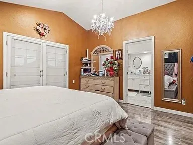 a bedroom with a bed and a chandelier
