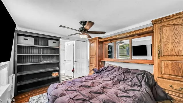 a bedroom with a large bed and a chandelier