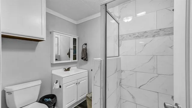 a bathroom with a toilet sink and shower