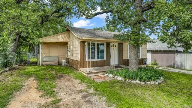a view of backyard of house with green space