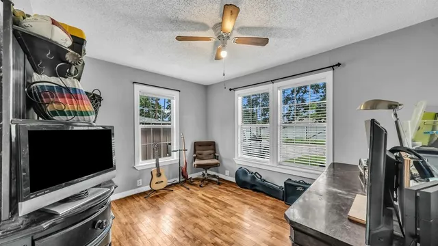 a bedroom with furniture and a flat screen tv